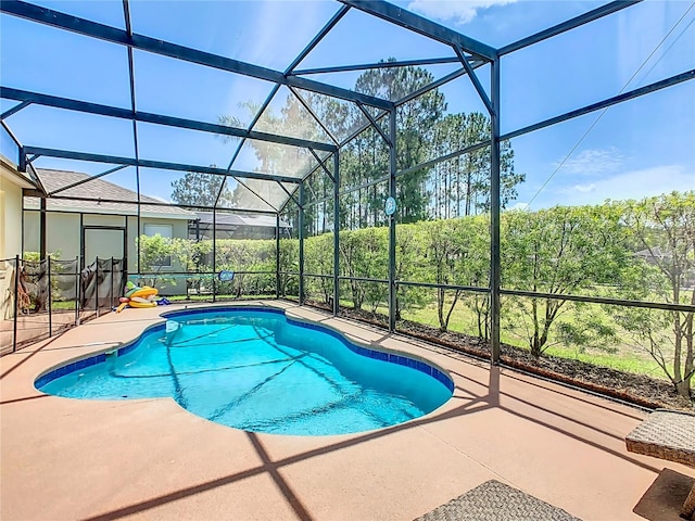 view of swimming pool with a lanai and a patio