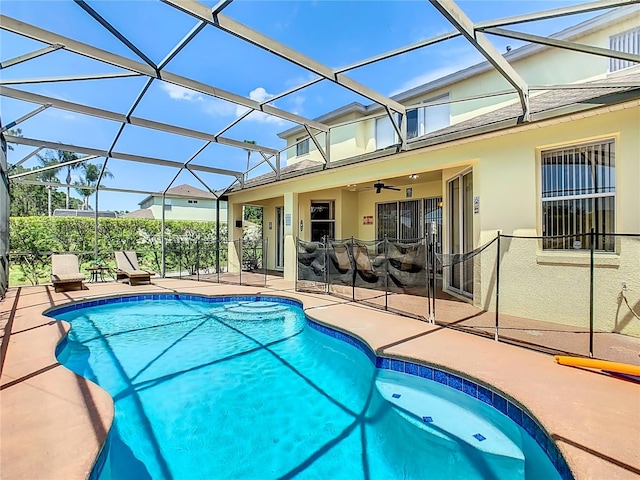 view of pool featuring a lanai, ceiling fan, and a patio area