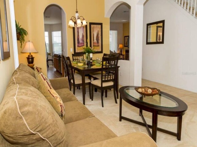 573 Viola Dr, Davenport, FL 33837 - dining space featuring arched walkways and a chandelier