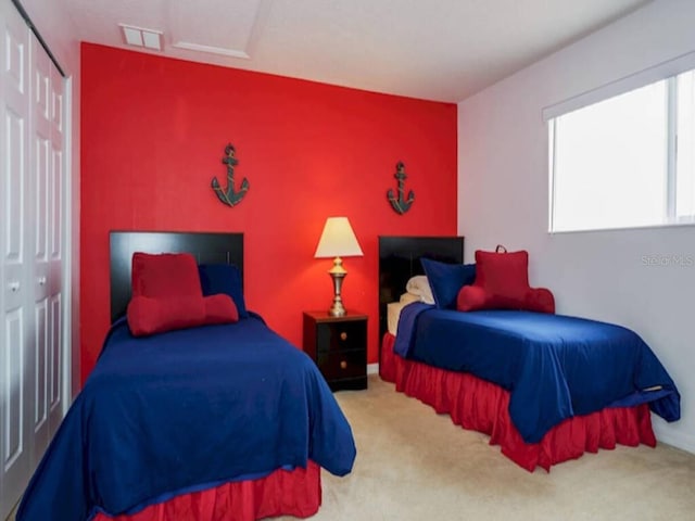 bedroom featuring carpet and a closet