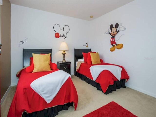 573 Viola Dr, Davenport, FL 33837 - carpeted bedroom with baseboards