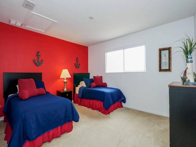 573 Viola Dr, Davenport, FL 33837 - carpeted bedroom featuring attic access and an accent wall