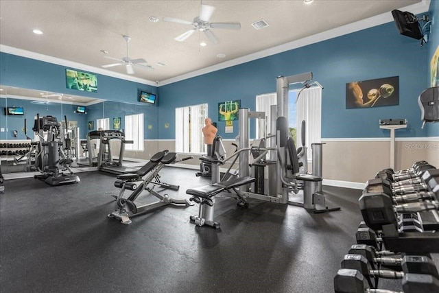 workout area with a textured ceiling, ceiling fan, and crown molding