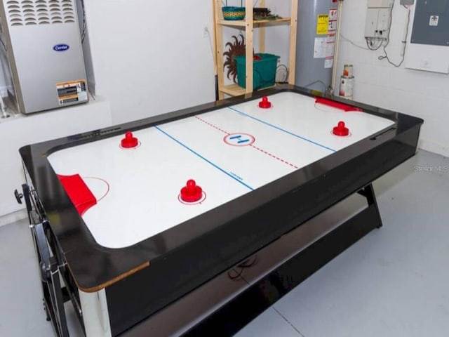 game room featuring concrete floors and gas water heater