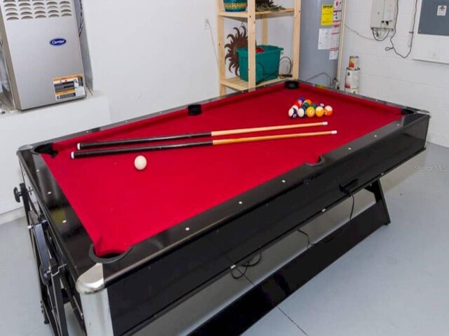 573 Viola Dr, Davenport, FL 33837 - playroom featuring gas water heater, billiards, and concrete floors