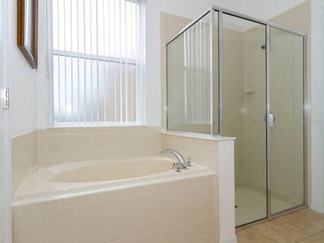 573 Viola Dr, Davenport, FL 33837 - full bath featuring a shower stall, a bath, and tile patterned flooring