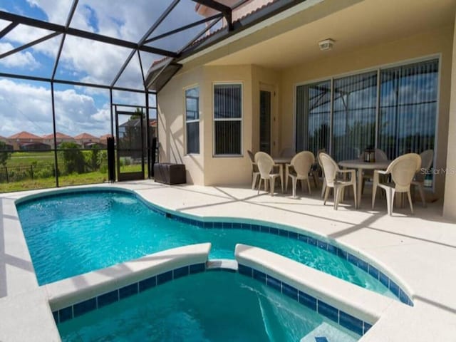 view of swimming pool featuring a patio and glass enclosure