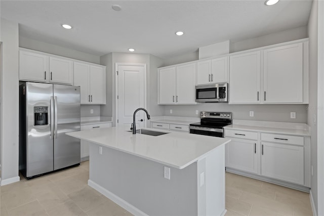 kitchen featuring white cabinetry, sink, a center island with sink, and appliances with stainless steel finishes