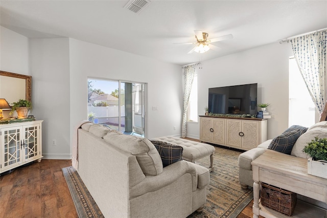 living room with dark hardwood / wood-style floors and ceiling fan