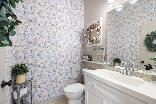 bathroom with tile patterned flooring, vanity, and toilet