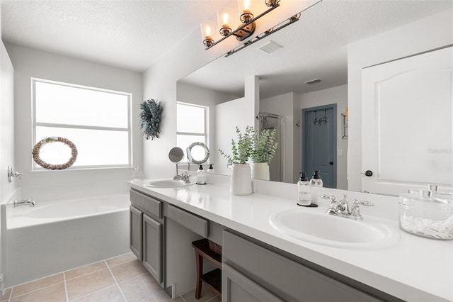 bathroom featuring tile patterned flooring, vanity, independent shower and bath, and a textured ceiling