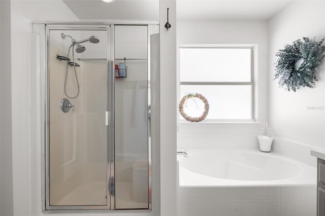 bathroom featuring shower with separate bathtub and vanity