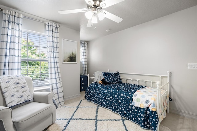 carpeted bedroom with ceiling fan