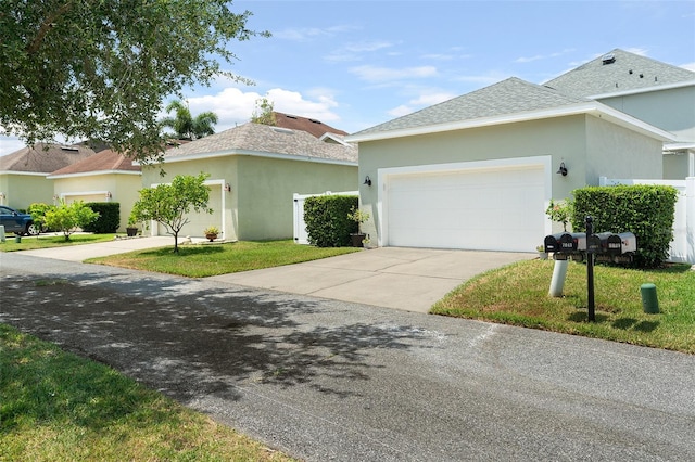 view of front of house with a garage and a front yard