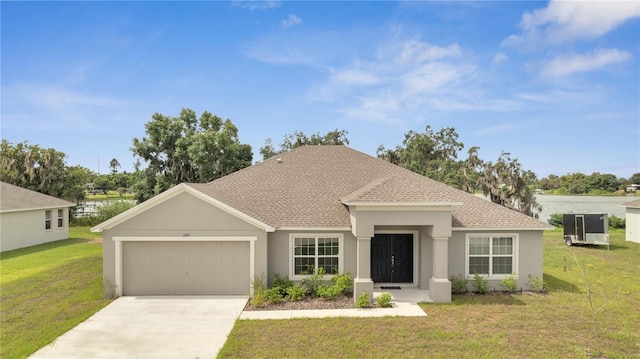 view of front of house featuring a front yard and a garage