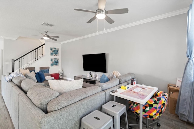 living room with crown molding, wood-type flooring, and ceiling fan