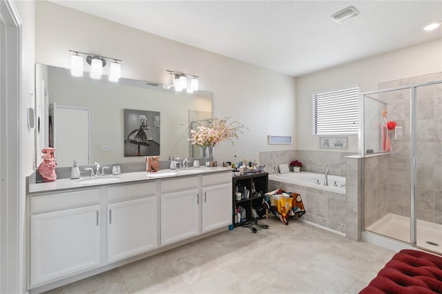 bathroom featuring vanity, independent shower and bath, and tile patterned flooring