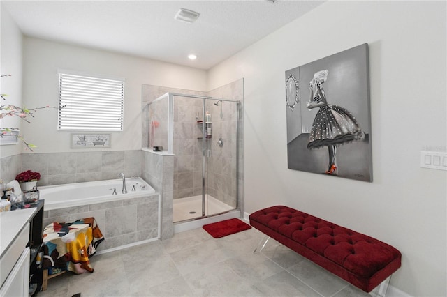 bathroom with tile patterned flooring, vanity, and plus walk in shower