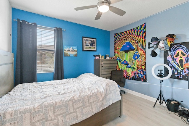 bedroom with ceiling fan and light hardwood / wood-style floors