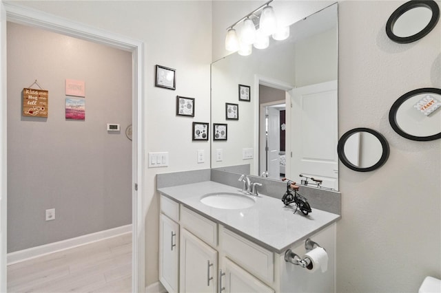 bathroom with vanity and hardwood / wood-style floors