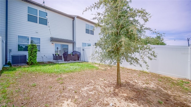 rear view of property with cooling unit