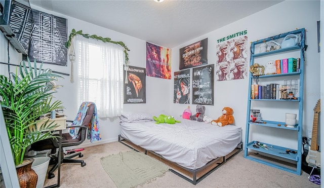 bedroom with carpet floors and a textured ceiling