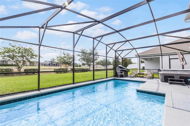 view of swimming pool featuring a hot tub, a patio, a lanai, and a yard