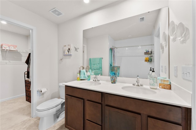 bathroom featuring a shower, vanity, and toilet