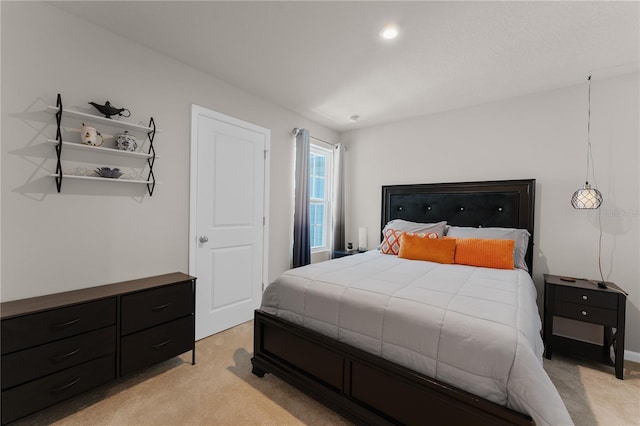 bedroom featuring light colored carpet