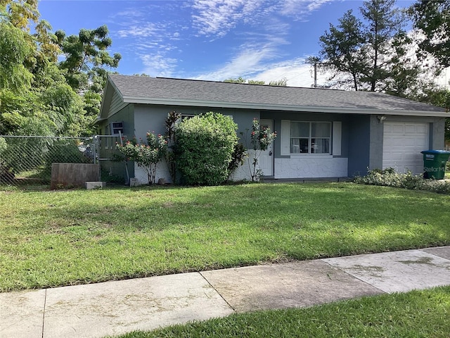 ranch-style home with a front lawn and a garage