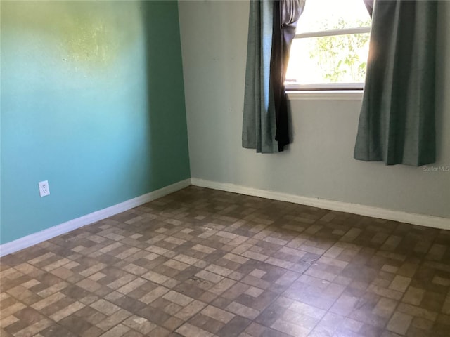 101 Albert St, Winter Springs, FL 32708 - empty room with baseboards and brick patterned floor