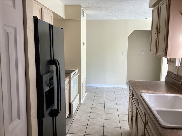 101 Albert St, Winter Springs, FL 32708 - kitchen with light tile patterned floors, visible vents, a sink, black fridge, and electric stove