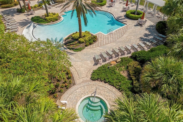 pool featuring a hot tub and a patio