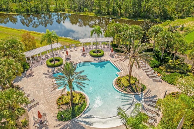 pool with a patio area, a water view, and a pergola