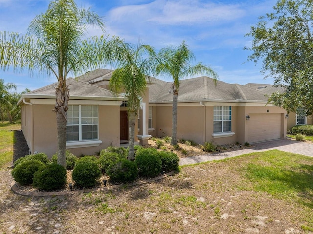 ranch-style house with a garage and a front yard