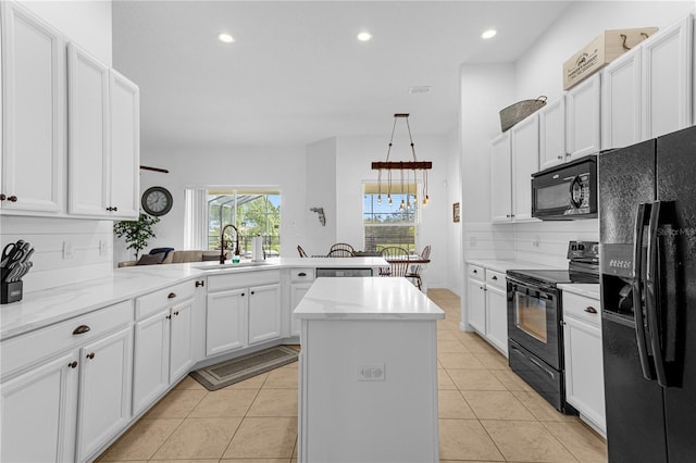 kitchen with a center island, black appliances, sink, tasteful backsplash, and kitchen peninsula