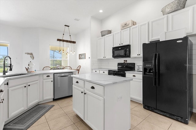 kitchen with white cabinetry, sink, a kitchen island, and black appliances