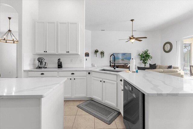 kitchen featuring light stone countertops, sink, pendant lighting, light tile patterned floors, and white cabinetry