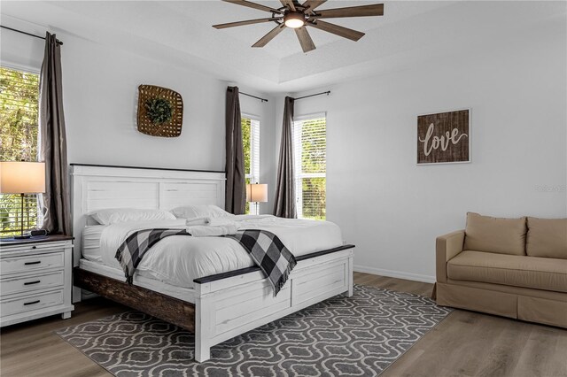 bedroom featuring ceiling fan and dark hardwood / wood-style floors