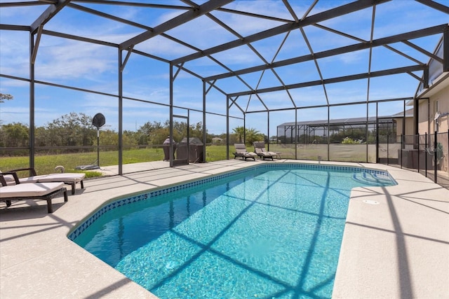 outdoor pool featuring glass enclosure and a patio area