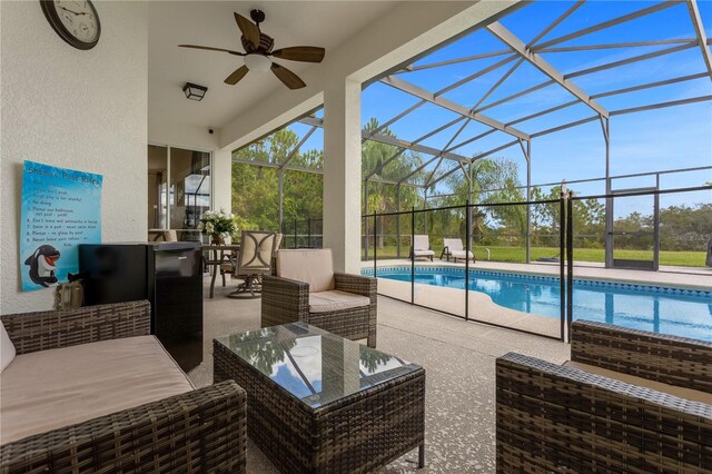 exterior space with ceiling fan, a lanai, an outdoor living space, and a patio