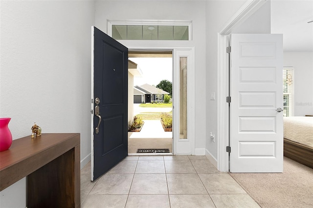 foyer entrance with plenty of natural light and light tile patterned floors