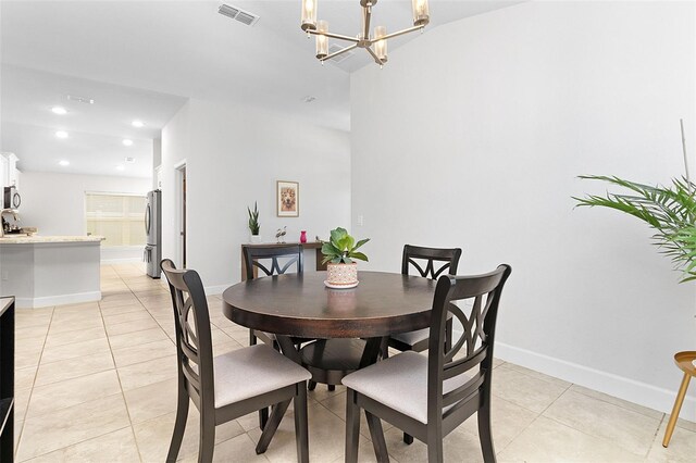 tiled dining space featuring a chandelier