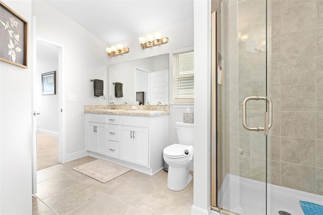 bathroom featuring tile patterned flooring, vanity, toilet, and a shower with shower door