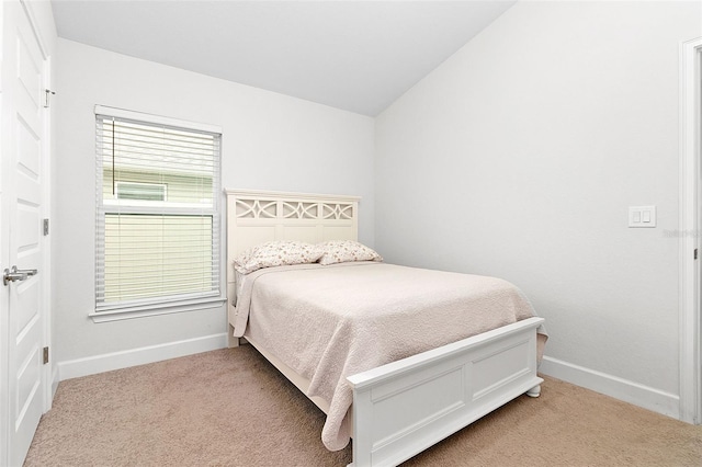 carpeted bedroom with vaulted ceiling