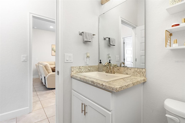 bathroom featuring toilet, vanity, and tile patterned floors