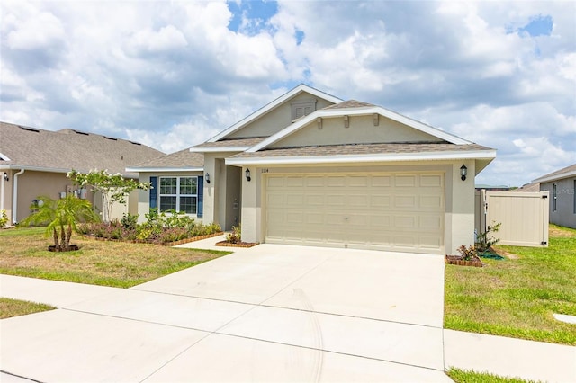 view of front facade with a garage and a front lawn