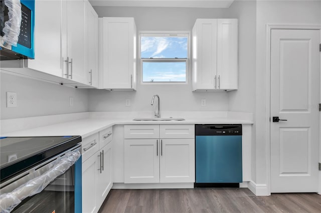 kitchen featuring white cabinetry, sink, stainless steel appliances, and light hardwood / wood-style flooring