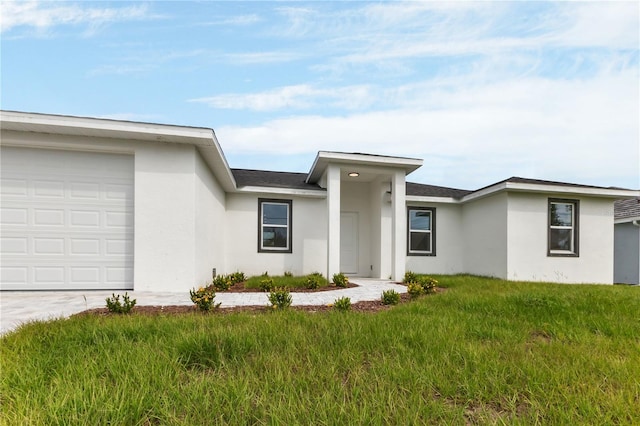 ranch-style home featuring a front yard and a garage