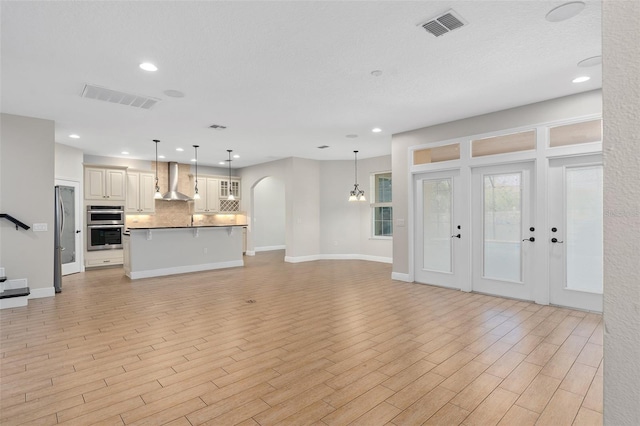 unfurnished living room featuring light wood-type flooring